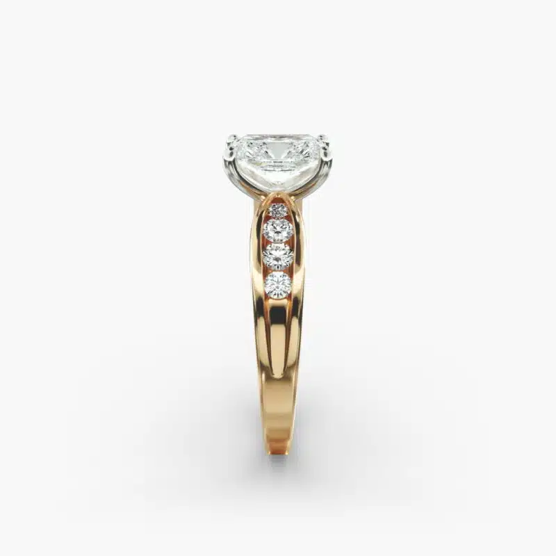 A close-up side view of a 2.5 carat radiant cut diamond ring in 14k yellow gold, highlighting the channel-set diamonds.