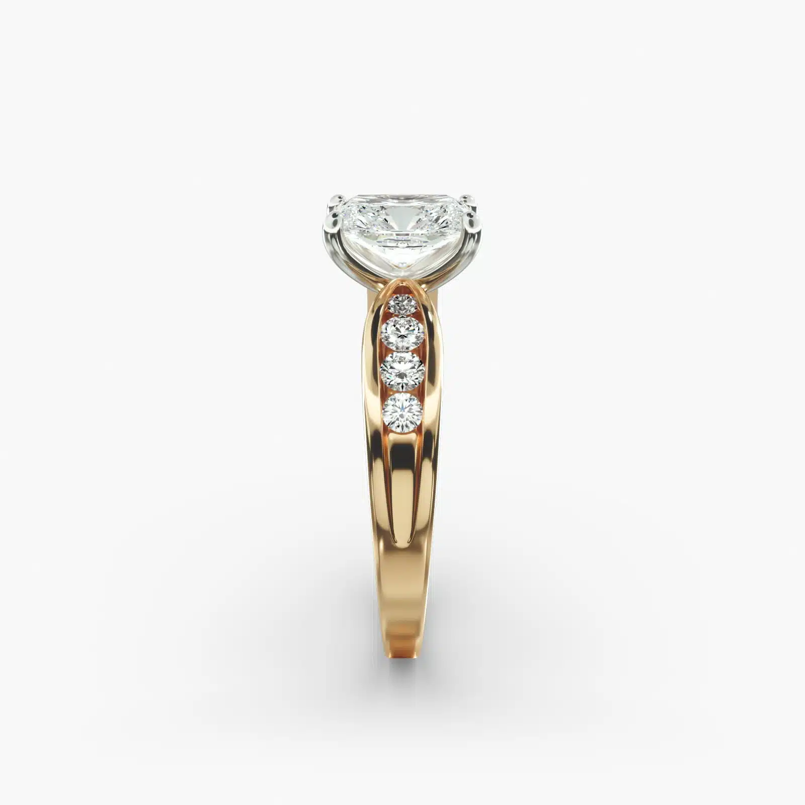 A close-up side view of a 2.5 carat radiant cut diamond ring in 14k yellow gold, highlighting the channel-set diamonds.