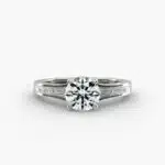 A close-up studio shot of a **Hearts and Arrows Diamond Engagement Ring**, highlighting the precise cut of the main diamond and the sleek, geometric lines of the tapered baguette side diamonds in a platinum setting.