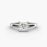 A close-up side view of a simple solitaire 2 carat princess cut lab-grown diamond engagement ring, highlighting the stone's setting in 14k white gold.