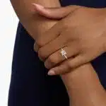 A hand wearing a classic 2 carat princess cut lab-grown diamond engagement ring, showing off the E-VVS1 center stone.
