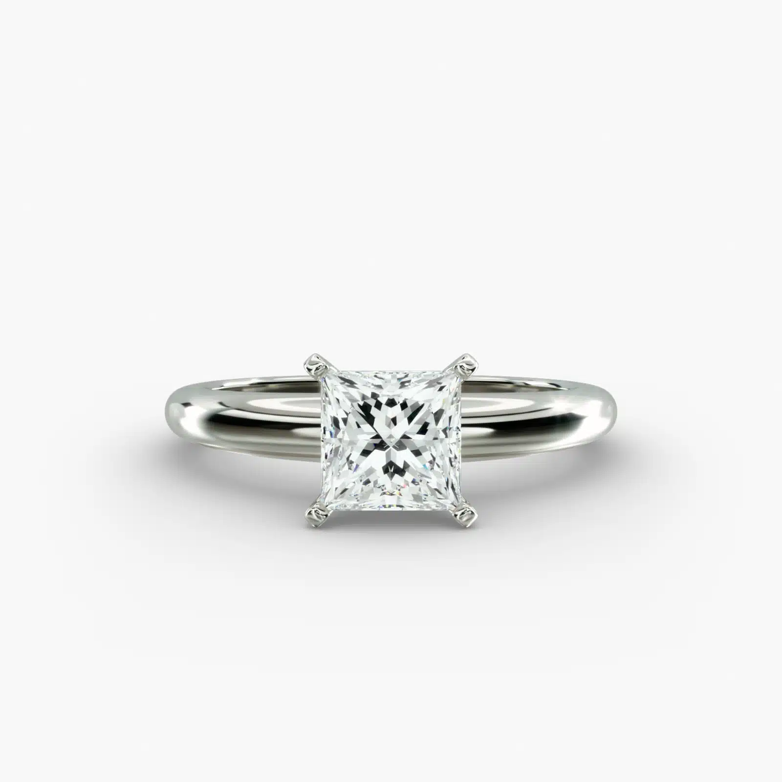 A close-up side view of a simple solitaire 2 carat princess cut lab-grown diamond engagement ring, highlighting the stone's setting in 14k white gold.