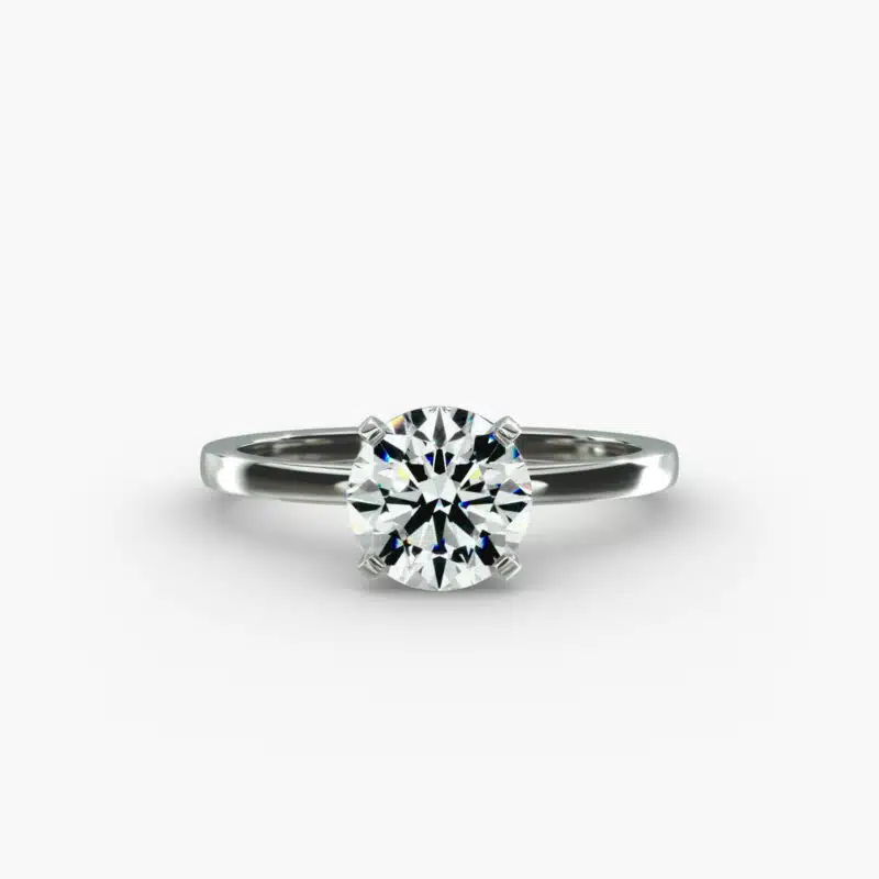 A close-up studio shot of a **Hearts and Arrows Diamond Engagement Ring**, highlighting the perfect proportions of the solitaire diamond and the classic design of the 14K white gold band.