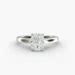 A close-up side view of a 4 carat radiant cut diamond ring, highlighting the secure prongs and the tapered 14k white gold band.