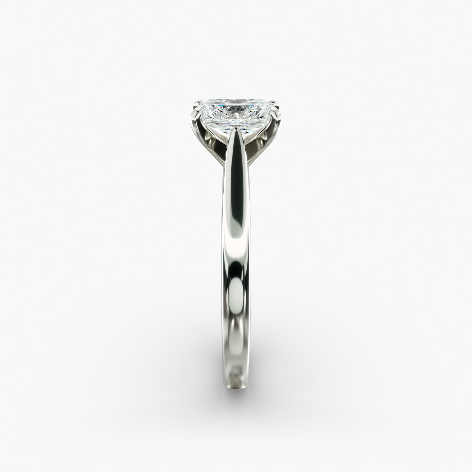 A close-up side view of a 4 carat radiant cut diamond ring, highlighting the secure prongs and the tapered 14k white gold band.