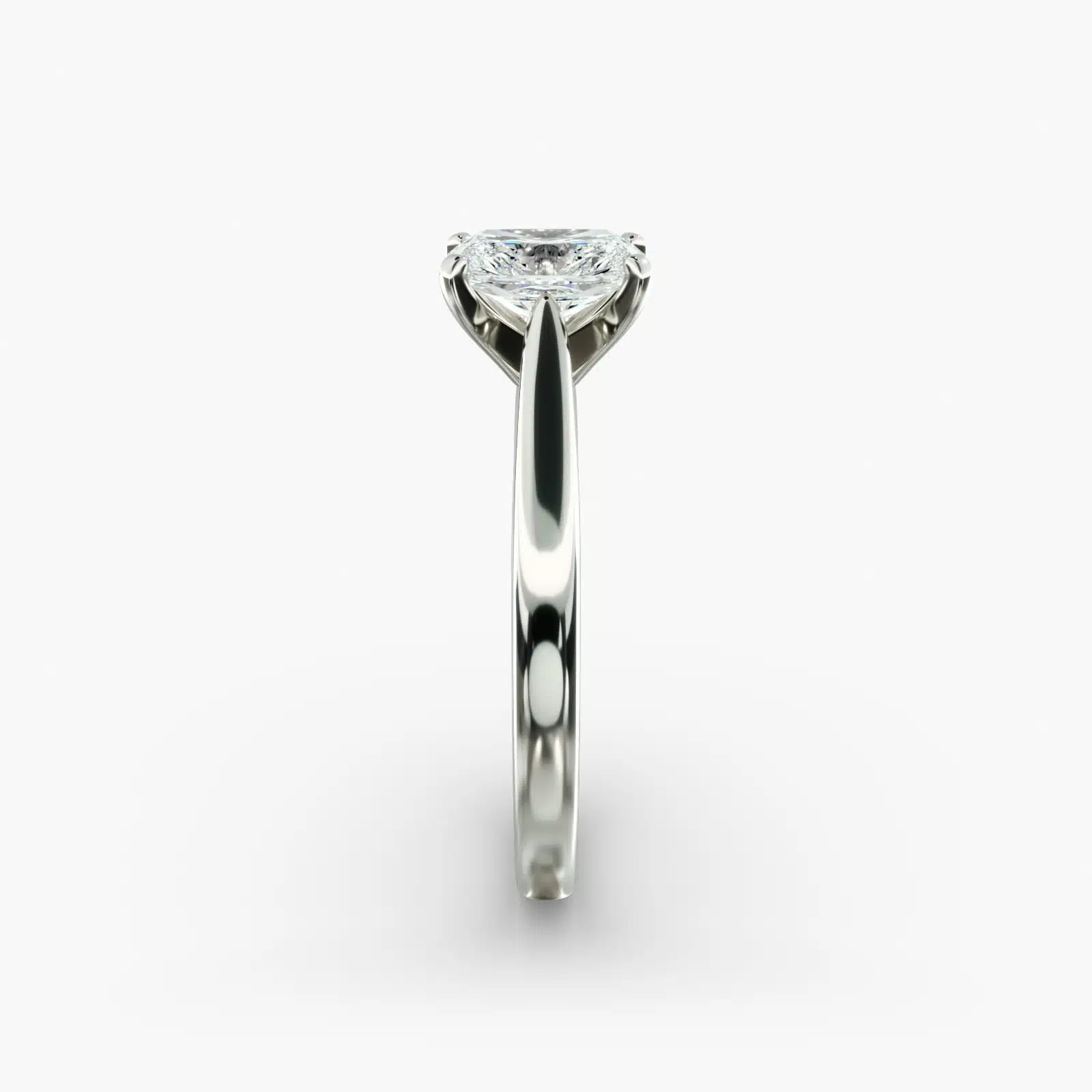 A close-up side view of a 4 carat radiant cut diamond ring, highlighting the secure prongs and the tapered 14k white gold band.