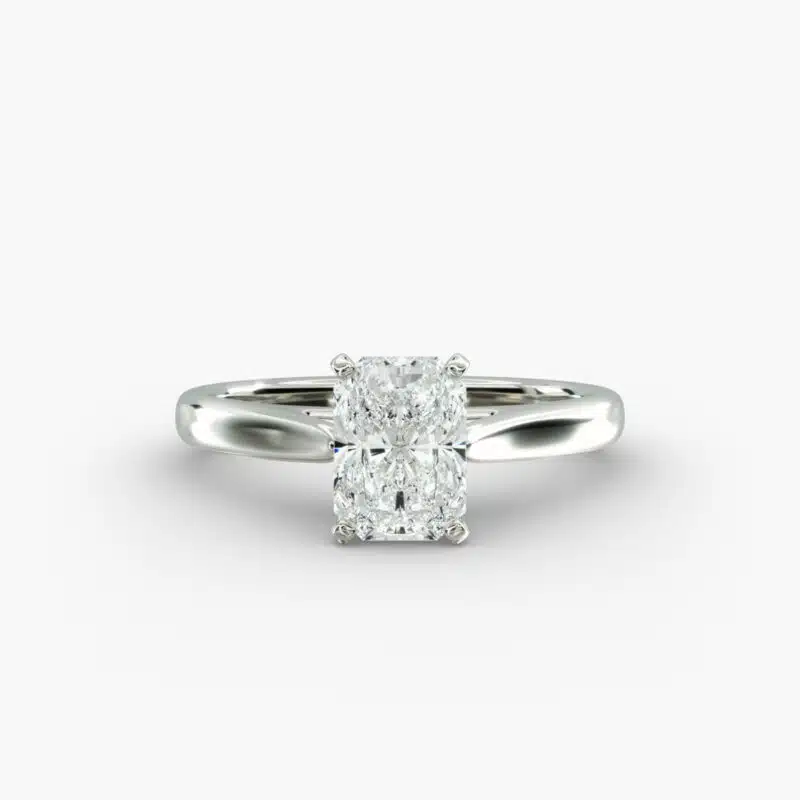 A close-up side view of a 4 carat radiant cut diamond ring, highlighting the secure prongs and the tapered 14k white gold band.