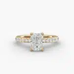 A close-up side view of a 3ct radiant cut diamond ring, showcasing the narrow 1.80mm yellow gold band and the subtle micropavé sparkle.