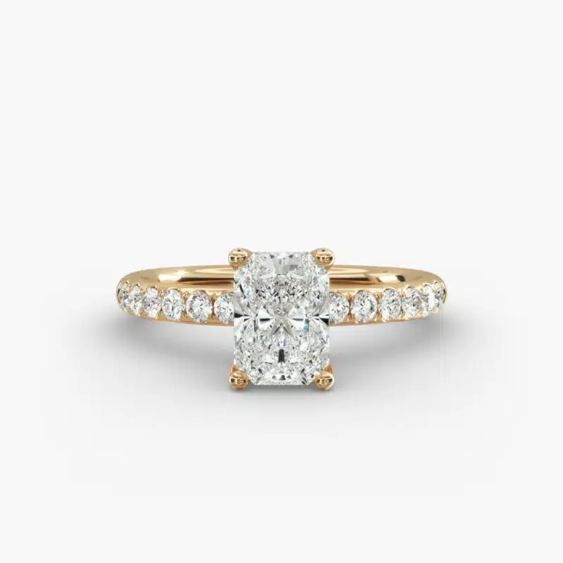 A close-up side view of a 3ct radiant cut diamond ring, showcasing the narrow 1.80mm yellow gold band and the subtle micropavé sparkle.