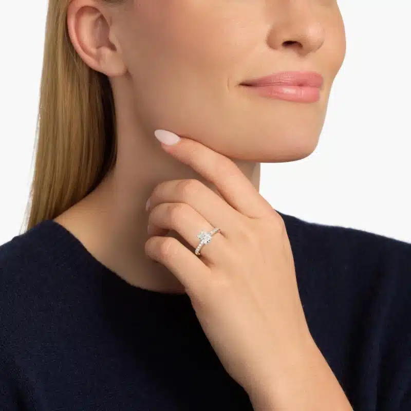 A hand wearing a showstopping 3 carat radiant cut diamond ring with a D-VVS2 center stone and a yellow gold Mini Micropavé band.