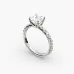 A close-up studio shot of a **7 carat diamond ring**, highlighting the sharp corners of the Princess cut diamond and the delicate detail of the French pavé side stones.