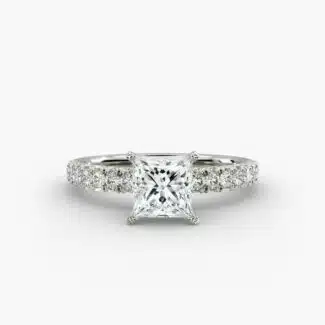 A close-up side view of a 2 carat princess cut diamond engagement ring, highlighting the F-VVS1 clarity of the center stone and the detailed French pavé setting.