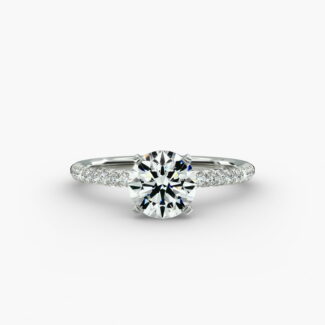 A studio shot of a **Hearts and Arrows Diamond Engagement Ring**, highlighting the precision cut of the round diamond and the delicate pavé side stones on the 14K white gold band.