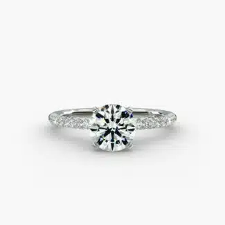 A studio shot of a **Hearts and Arrows Diamond Engagement Ring**, highlighting the precision cut of the round diamond and the delicate pavé side stones on the 14K white gold band.