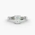 A close-up side view of a 2 carat radiant cut diamond ring, highlighting the F-VS1 clarity of the center stone and the elegant twist setting.