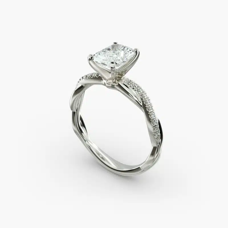 A close-up side view of a 2 carat radiant cut diamond ring, highlighting the F-VS1 clarity of the center stone and the elegant twist setting.