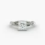 A close-up studio shot of a 2 carat princess cut diamond engagement ring, highlighting the sharp corners of the D-IF diamond and the twisting pavé setting.