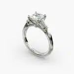 A close-up studio shot of a 2 carat princess cut diamond engagement ring, highlighting the straight lines of the princess and baguette diamonds set in 14K white gold.