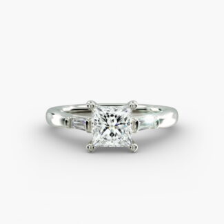 A close-up studio shot of a 2 carat princess cut diamond engagement ring, highlighting the straight lines of the princess and baguette diamonds set in 14K white gold.