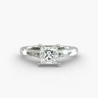 A close-up studio shot of a 2 carat princess cut diamond engagement ring, highlighting the straight lines of the princess and baguette diamonds set in 14K white gold.