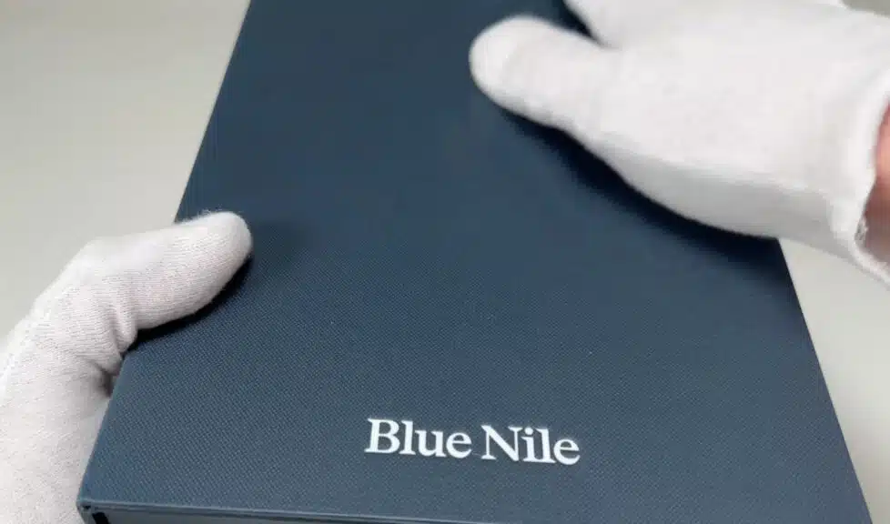 The elegant, dark blue outer packaging for a Blue Nile engagement ring, with the brand name embossed on the lid.
