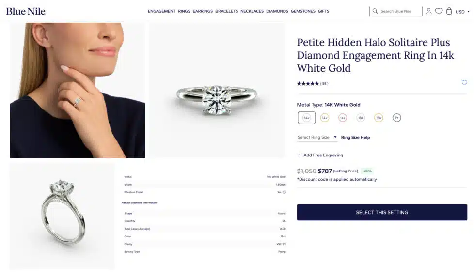 A screenshot of the Petite Hidden Halo Solitaire Plus engagement ring setting details from the Blue Nile website, made with 14k white gold.
