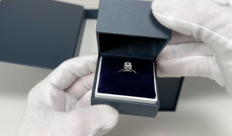 The first look at the Blue Nile oval lab-grown diamond engagement ring, sparkling inside the open ring box on a velvet cushion.