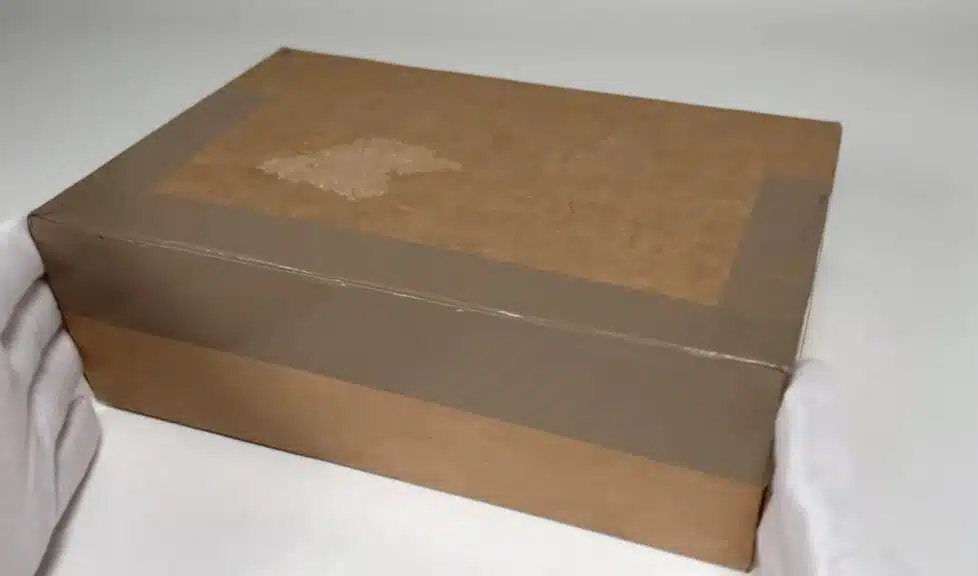 The first layer of the Blue Nile unboxing experience: a taped-up shipping box, ready to be opened to reveal a diamond engagement ring.