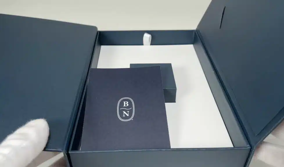 An overview of the Blue Nile box contents, including the small ring box and brand literature, neatly placed inside the larger presentation box.
