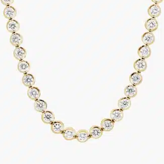A spectacular lab created diamond tennis necklace featuring 20 CTW of F-G/VS2-SI1 round lab-grown diamonds in an illusion setting, handcrafted in radiant 14K Yellow Gold.