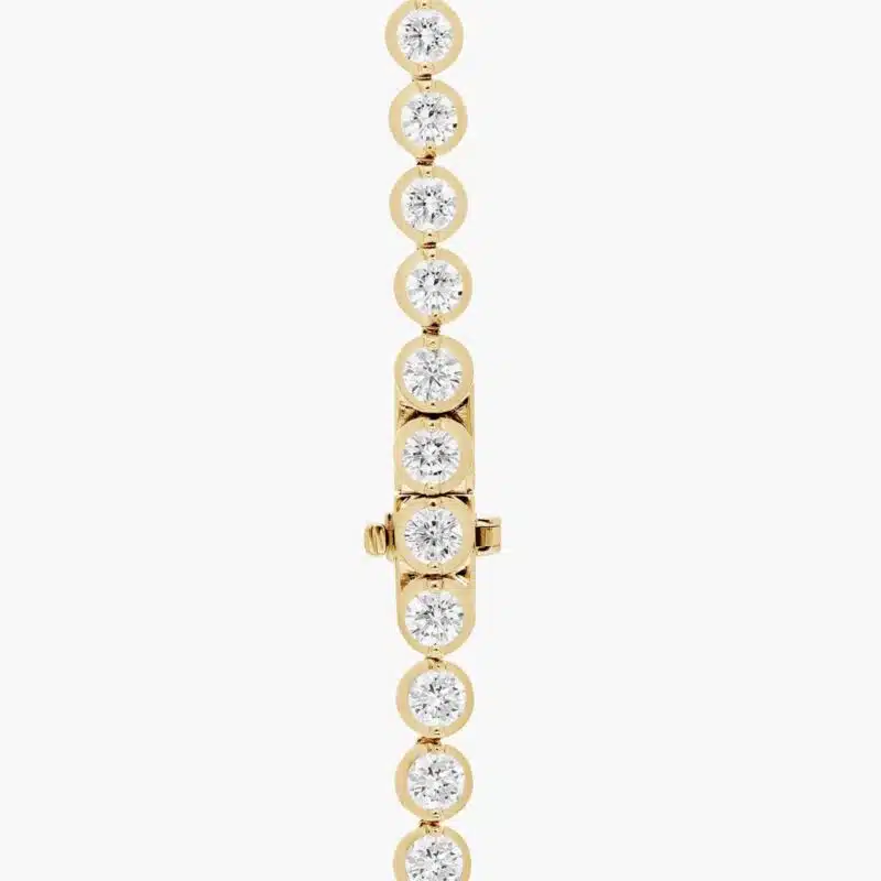 A spectacular lab created diamond tennis necklace featuring 20 CTW of F-G/VS2-SI1 round lab-grown diamonds in an illusion setting, handcrafted in radiant 14K Yellow Gold.