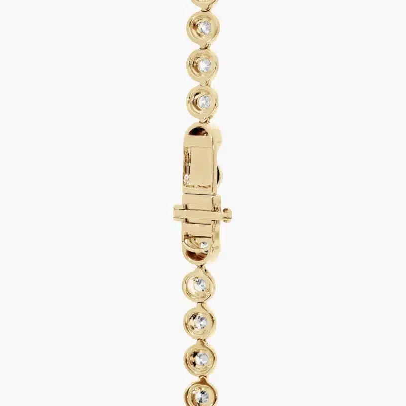 A spectacular lab created diamond tennis necklace featuring 20 CTW of F-G/VS2-SI1 round lab-grown diamonds in an illusion setting, handcrafted in radiant 14K Yellow Gold.