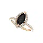A close-up view of a marquise cut diamond ring, highlighting the 10x5 MM black onyx center stone and prong setting.