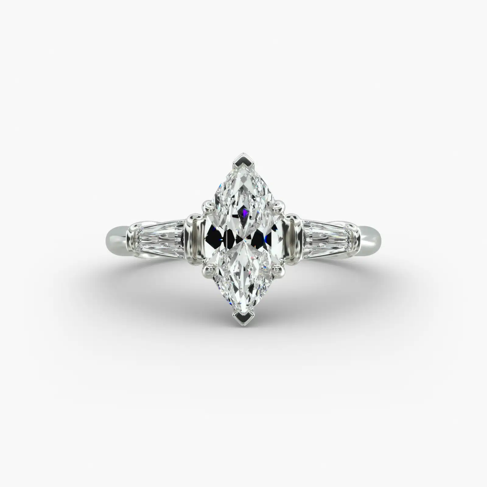 A close-up studio shot of a marquise cut diamond ring, highlighting the straight lines of the tapered baguette side stones against the center diamond.