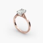 A close-up view of a rectangular radiant cut diamond solitaire, highlighting the warm rose gold band and large 7.00 ct. stone.
