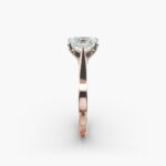 A close-up view of a rectangular radiant cut diamond solitaire, highlighting the warm rose gold band and large 7.00 ct. stone.