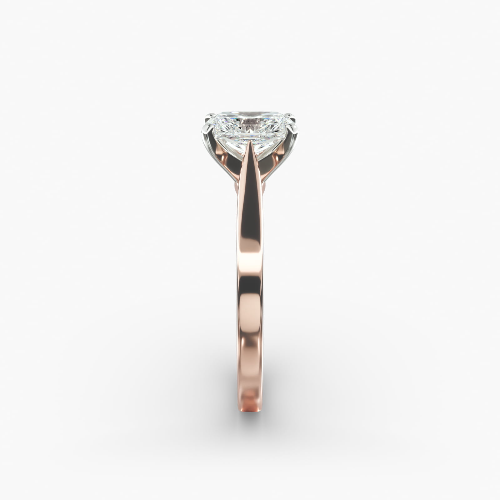 A close-up view of a rectangular radiant cut diamond solitaire, highlighting the warm rose gold band and large 7.00 ct. stone.