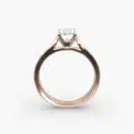 A close-up view of a rectangular radiant cut diamond solitaire, highlighting the warm rose gold band and large 7.00 ct. stone.