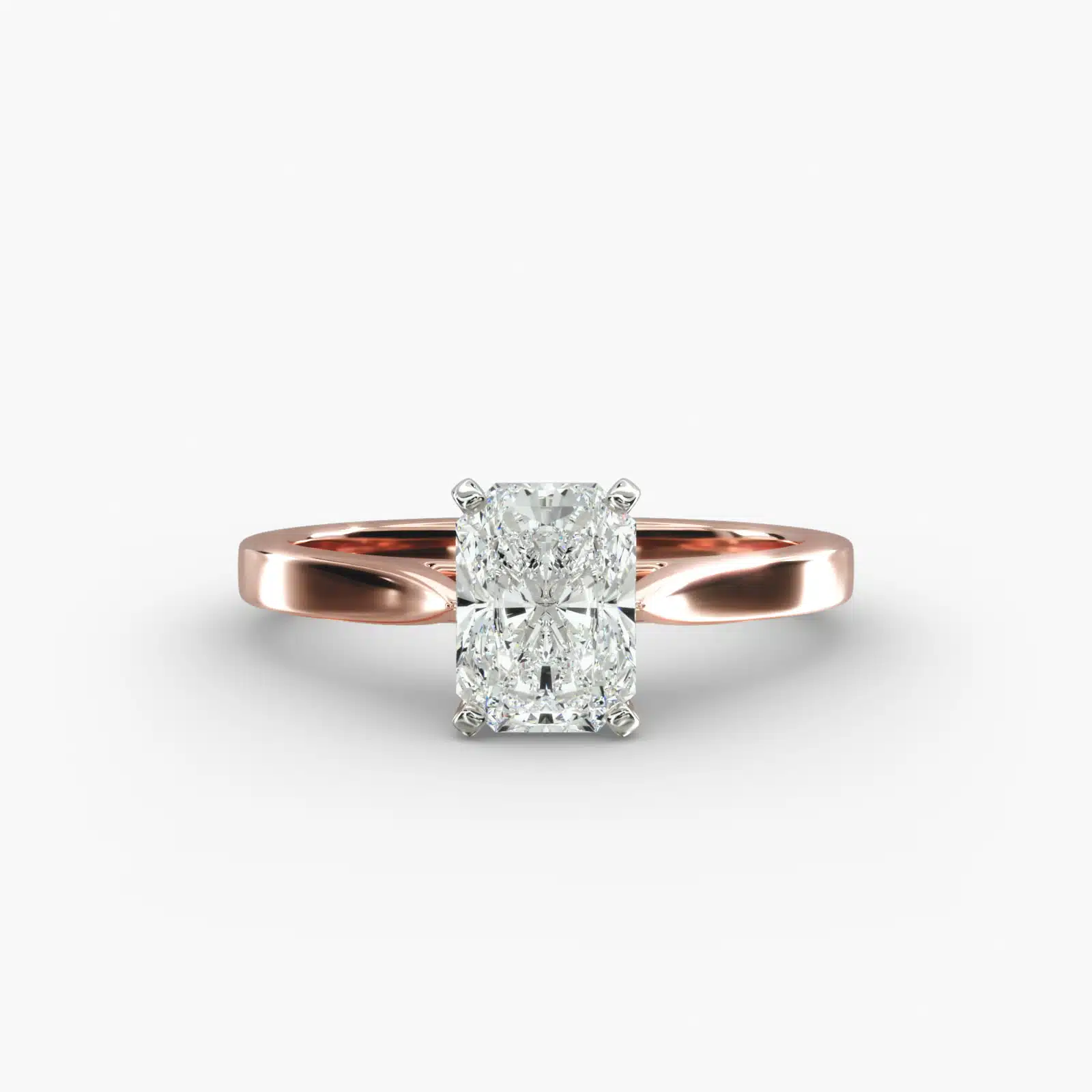 A close-up view of a rectangular radiant cut diamond solitaire, highlighting the warm rose gold band and large 7.00 ct. stone.