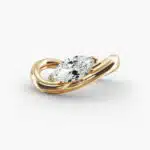 A close-up view of the marquise shaped diamond with prominent claw prongs on the Sculptural Waves yellow gold band.
