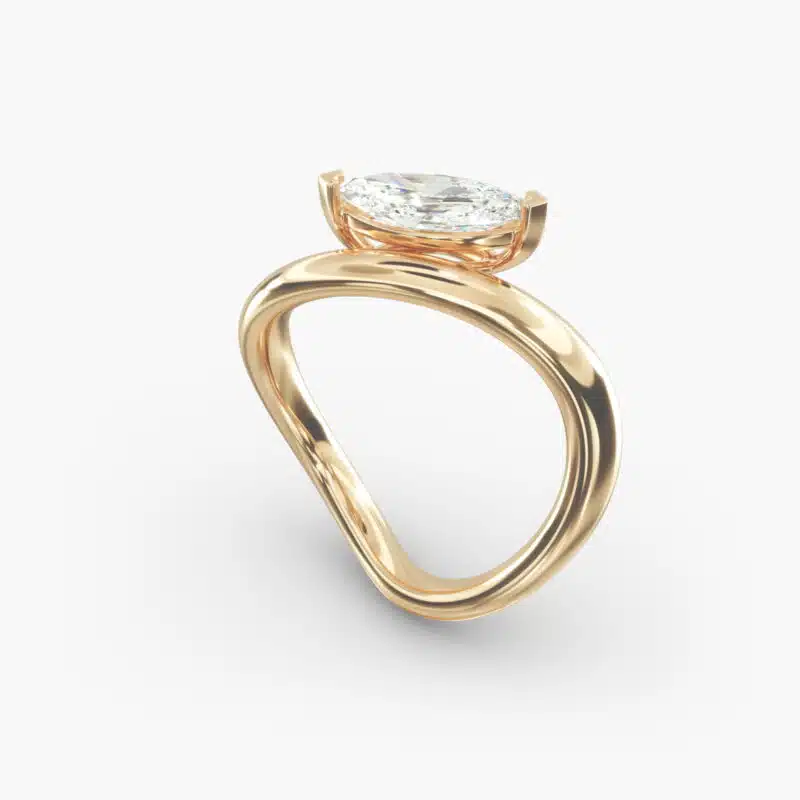 A close-up view of the marquise shaped diamond with prominent claw prongs on the Sculptural Waves yellow gold band.
