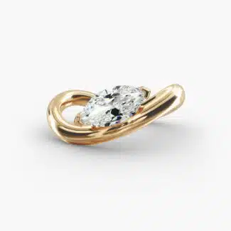 A close-up view of the marquise shaped diamond with prominent claw prongs on the Sculptural Waves yellow gold band.