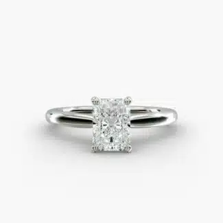 A close-up side view of a 6 ct radiant cut diamond ring, showcasing the delicate 1.60mm band and the hidden halo accent diamonds.