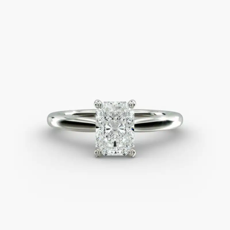 A close-up side view of a 6 ct radiant cut diamond ring, showcasing the delicate 1.60mm band and the hidden halo accent diamonds.