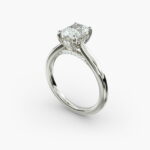 A close-up side view of a 6 ct radiant cut diamond ring, showcasing the delicate 1.60mm band and the hidden halo accent diamonds.