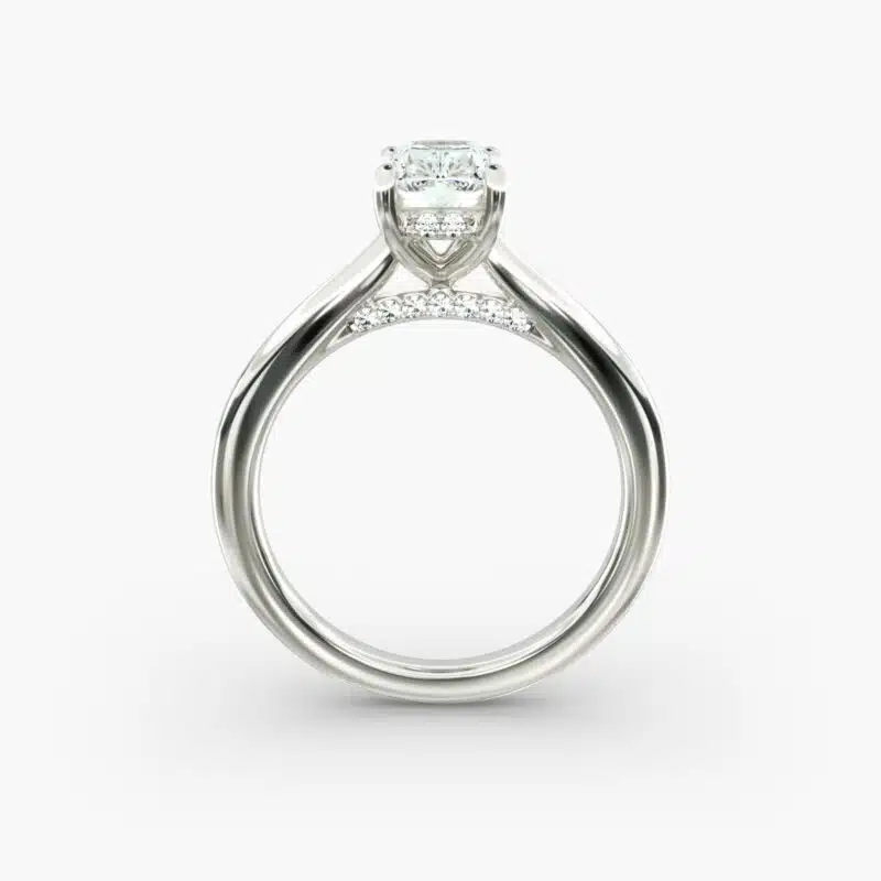 A close-up side view of a 6 ct radiant cut diamond ring, showcasing the delicate 1.60mm band and the hidden halo accent diamonds.