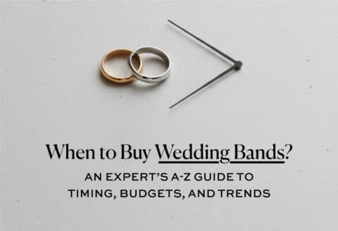 Gold and silver wedding bands with clock hands on a gray surface, symbolizing the best time to buy wedding rings.