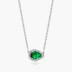 An East-West Pear Emerald (0.65 CT min) and Diamond Halo Necklace (0.14 CTW) in 18K White Gold, a modern and high-quality option among Luxury Push Present Ideas.