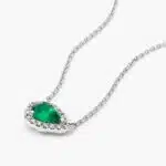 An East-West Pear Emerald (0.65 CT min) and Diamond Halo Necklace (0.14 CTW) in 18K White Gold, a modern and high-quality option among Luxury Push Present Ideas.