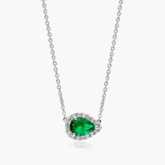 An East-West Pear Emerald (0.65 CT min) and Diamond Halo Necklace (0.14 CTW) in 18K White Gold, a modern and high-quality option among Luxury Push Present Ideas.
